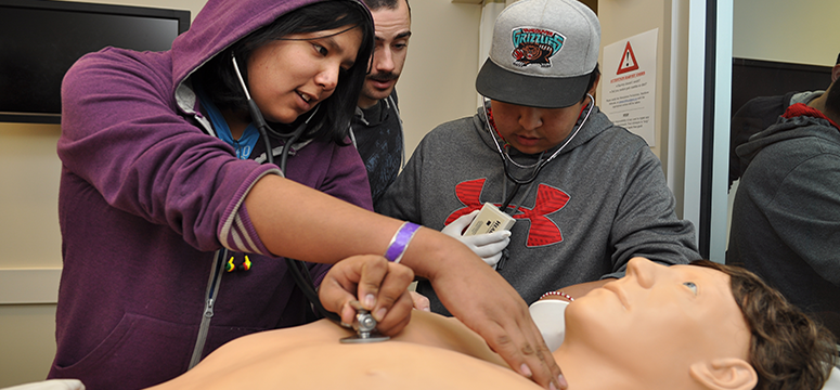 Students from Morley Community School interact with Harvey, a cardiac patient simulator mannequin, in the anatomy lab.