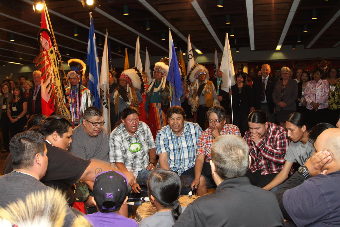 Flag bearers carry their representative flags during the Grande Entry marking the start of the evening's powwow. The event also marked the Native Centre's 40th anniversary at the University of Calgary.