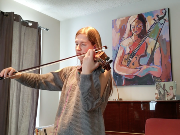 Woman violinist with painting