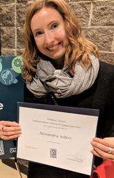 Alexandra Sellers holding URS award